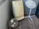 a small room with a fan and a table in it
