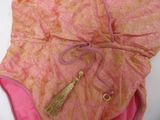 a pink bag with a tassel on top of it