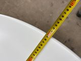 a measuring tape that is on top of a toilet