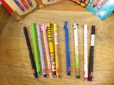 a lot of pens that are sitting on a table