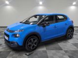 a blue citrole car parked in a showroom