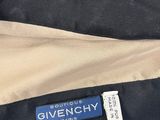a black and tan jacket with the label givenchy on it