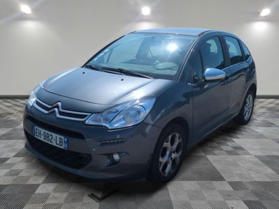 the grey citrole is parked in a room with checkered floor