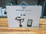 packaging of a box with a picture of a weather station on top of a wooden table