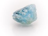 an image of a rough blue diamond on a white surface