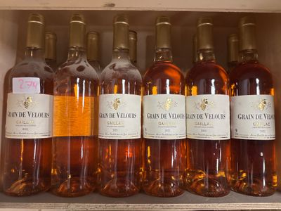 several bottles of wine are lined up in a wooden box