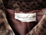 the label of a fur coat is shown on the back of a jacket