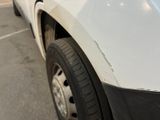 a close up of a white truck parked in a parking lot