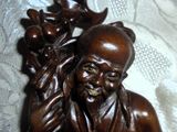 a wooden statue of a man holding a baby