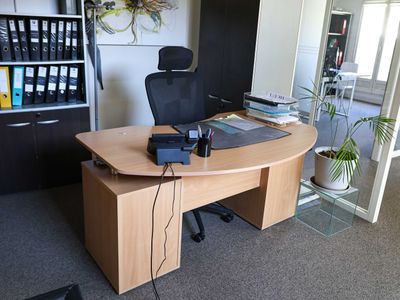 a desk with a chair and a laptop on it