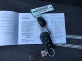 a book with a car key and a keychain on top of it