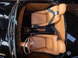 two leather seats in the back of a black car