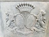 a stone plaque with a coat of arms and two lions on it