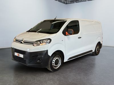 La camionnette blanche est garée dans le garage d'un immeuble.