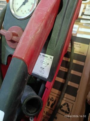 a close up of a red and green fire hydrant with a gauge
