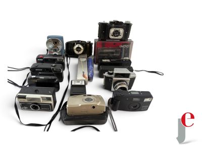 a lot of old cameras sitting on a white surface