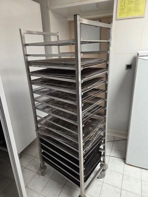 une étagère avec des plateaux de nourriture posés dessus, dans une cuisine