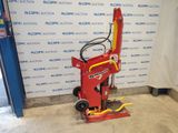 an image of a small red machine in a garage