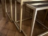 three metal nesting tables sitting on top of a hard wood floor