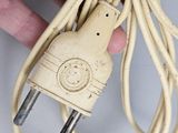 a person that is holding a power cord in their hand
