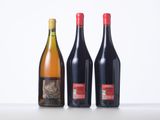 three bottles of wine sitting on a table next to each other