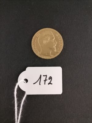 a gold coin with a price tag on it next to a string