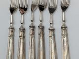 six silver plated forks and spoons on a white surface