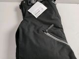 black backpack with a tag on it sitting on a white surface
