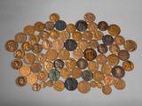 a pile of coins on a table with a white background