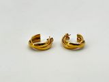 a pair of gold hoop earrings on a white surface