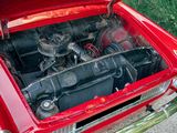 a red car with an engine in the trunk of it