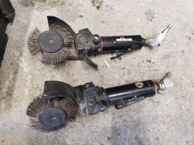 two brushes that are laying on the ground