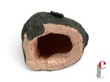 a small rock with a hole in it on a white surface