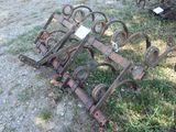 an old rusted out plow sitting in the grass
