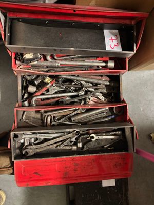 many tools in a red tool box on the floor