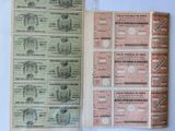 several bills of different sizes and colors are sitting on a table
