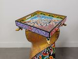 a small table with a colorful design on top of it