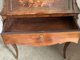 a wooden table with a drawer on top of it