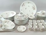 many different types of plates and bowls on the table