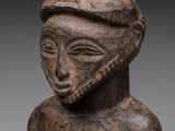 a close up of a statue of a person wearing a hat