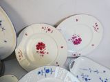 a lot of plates and bowls that are on the table