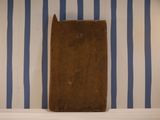 a wooden board sitting on a shelf in a room