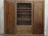 an image of a wooden cabinet with a glass door and shelves
