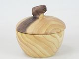 an apple shaped wooden box with a wooden lid on a white surface