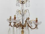 a small crystal chandelier on a table next to a lamp