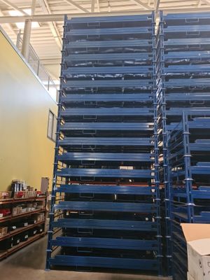 a large stack of pallets in a warehouse