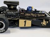 a model of a racing car on display on a white surface
