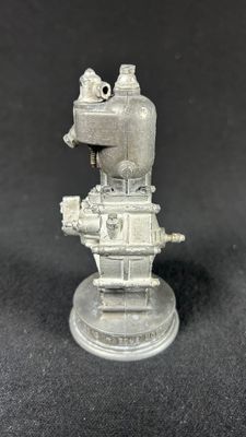 a close up of a small metal object on a black surface