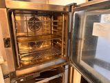 an open oven that has a lot of food inside of it