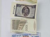 five different types of currency on a white surface